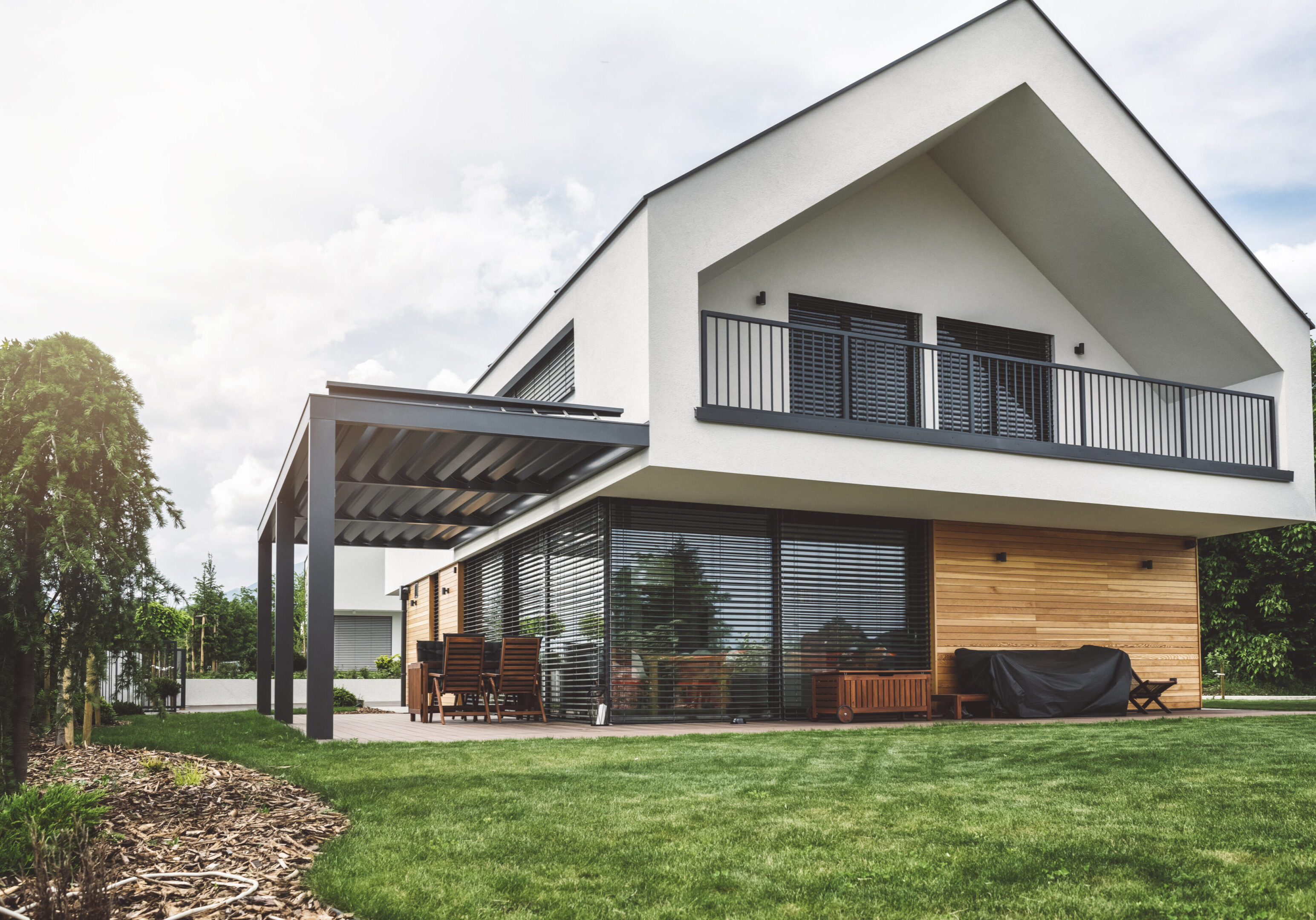 Modern two-story house with balcony and patio
